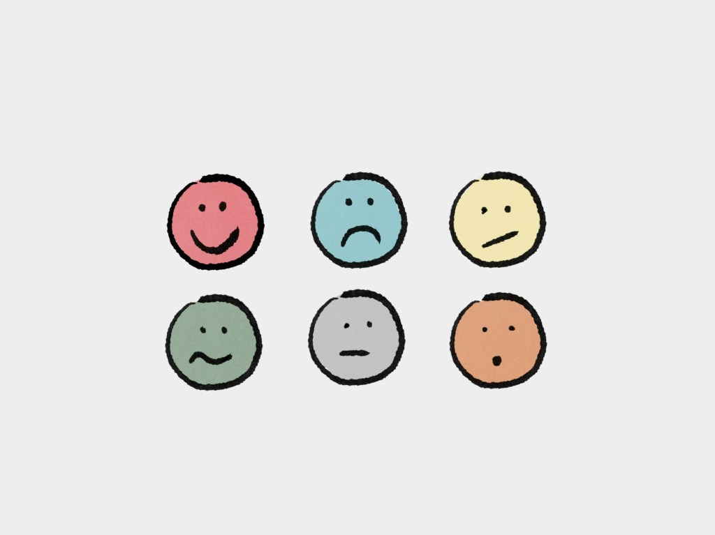 A grid of six cartoon-style facial expressions, including a smiling face, sad face, neutral face, and others in various colors.